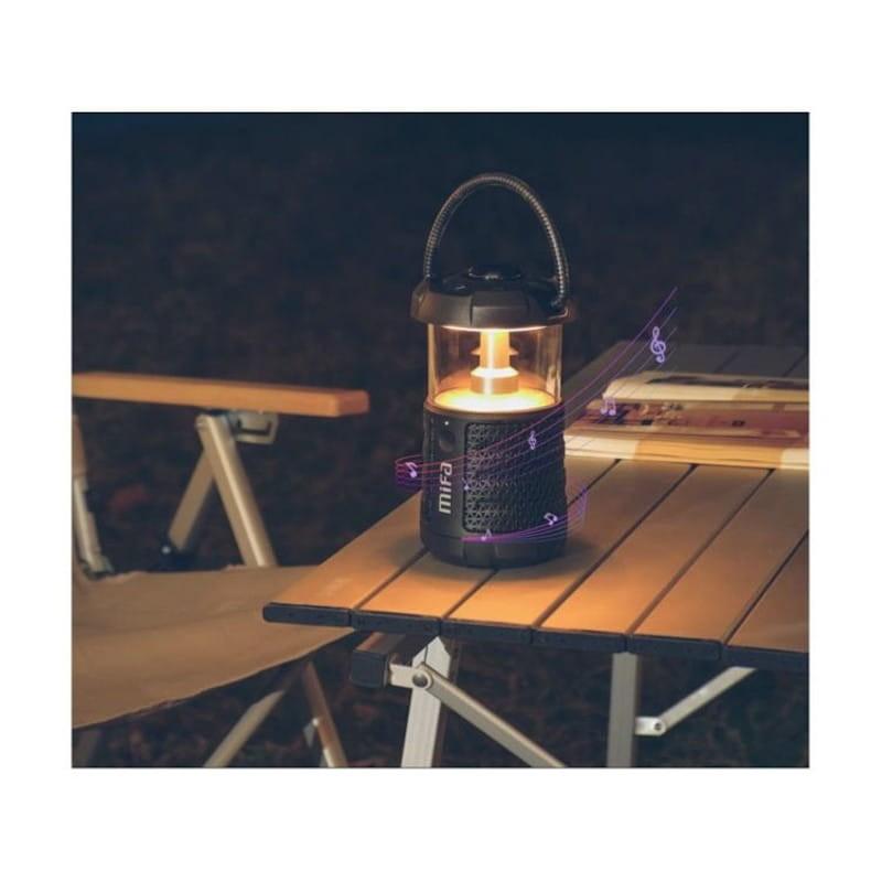 Haut-parleur portable Mifa Wild Camping Bluetooth Lanterne LED Noir sur une table