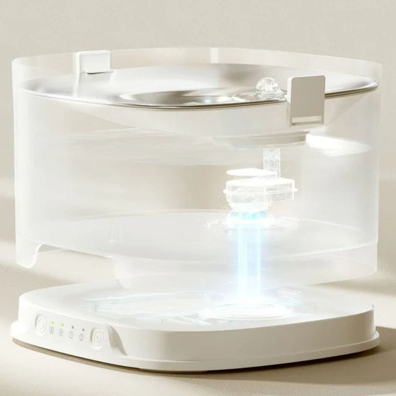Elfin Pet Fountain D1 Pro Bebedero Automático sin bomba con depósito transparente, base blanca con controles LED y sistema de filtrado visible en el centro