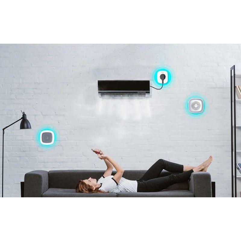 Heiman HS1HT Tuya Zigbee sensor blanco montado en pared, indicadores LED azules, monitorea temperatura y humedad, integra con aire acondicionado en sala moderna