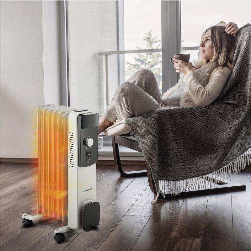 Blaupunkt BP1009 1500 W - Radiador de aceite, junto a un humano en una casa