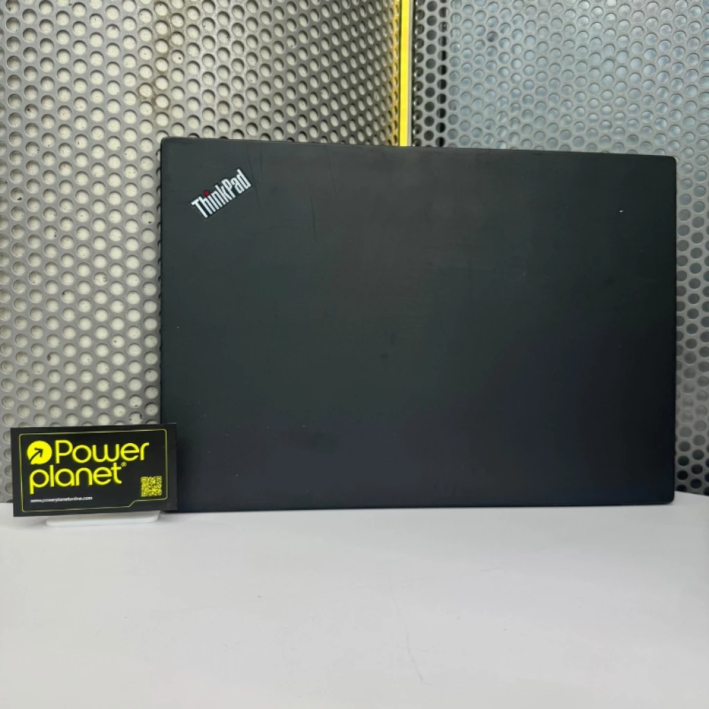 Tampa preta do Lenovo ThinkPad T490 com logotipo ThinkPad no canto, acabamento fosco com leves marcas de uso; fundo metálico perfurado e placa Powerplanet ao