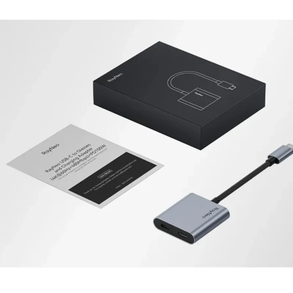 Adaptateur de charge USB-C pour lunettes AR RayNeo, boîtier compact en aluminium gris, câble court noir, port USB-C et indicateur, livré avec notice et