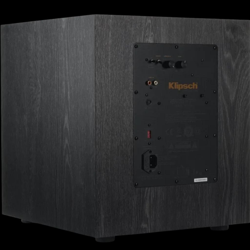 Subwoofer Klipsch SPL 100 CE 10 pol em madeira preta, painel traseiro com entradas RCA e LFE, controles de ganho e crossover, pés robustos e acabamento fosco