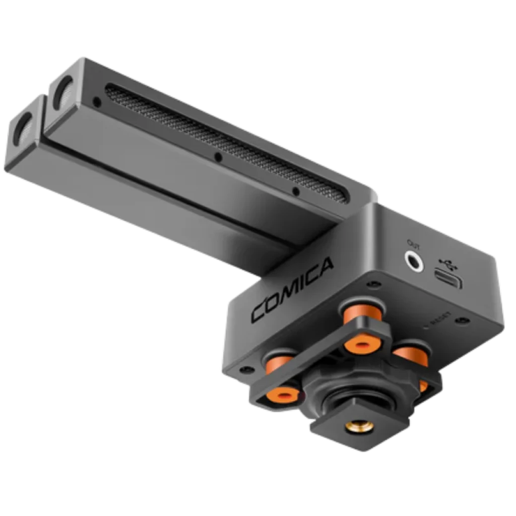 Microfone shotgun modular com duas cápsulas ajustáveis, corpo em metal cinza, base com amortecedores laranja, porta USB e saída de áudio, ecrã OLED