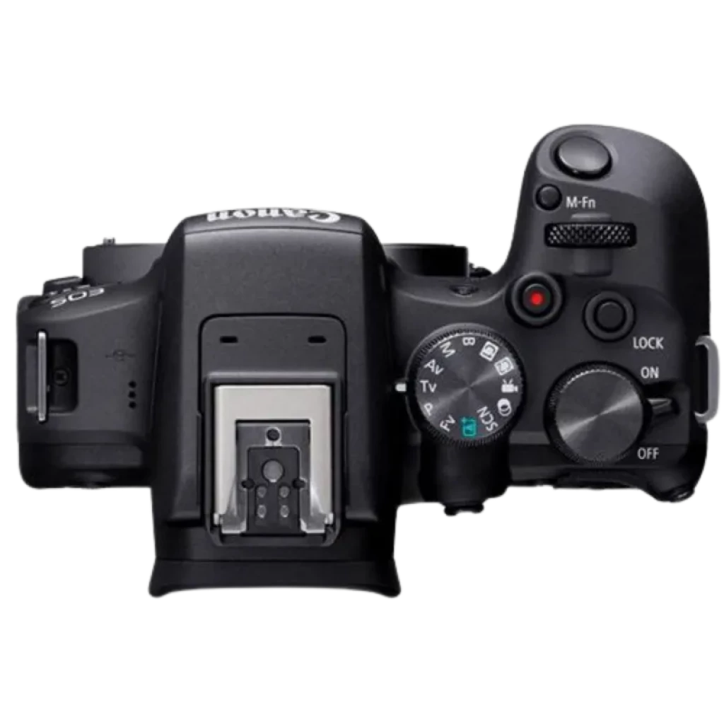 Vista superior de la Canon EOS R10: zapata metálica, dial de modos, botón disparo con dial, interruptor ON/OFF y rueda M-Fn; diseño compacto y ergonómico
