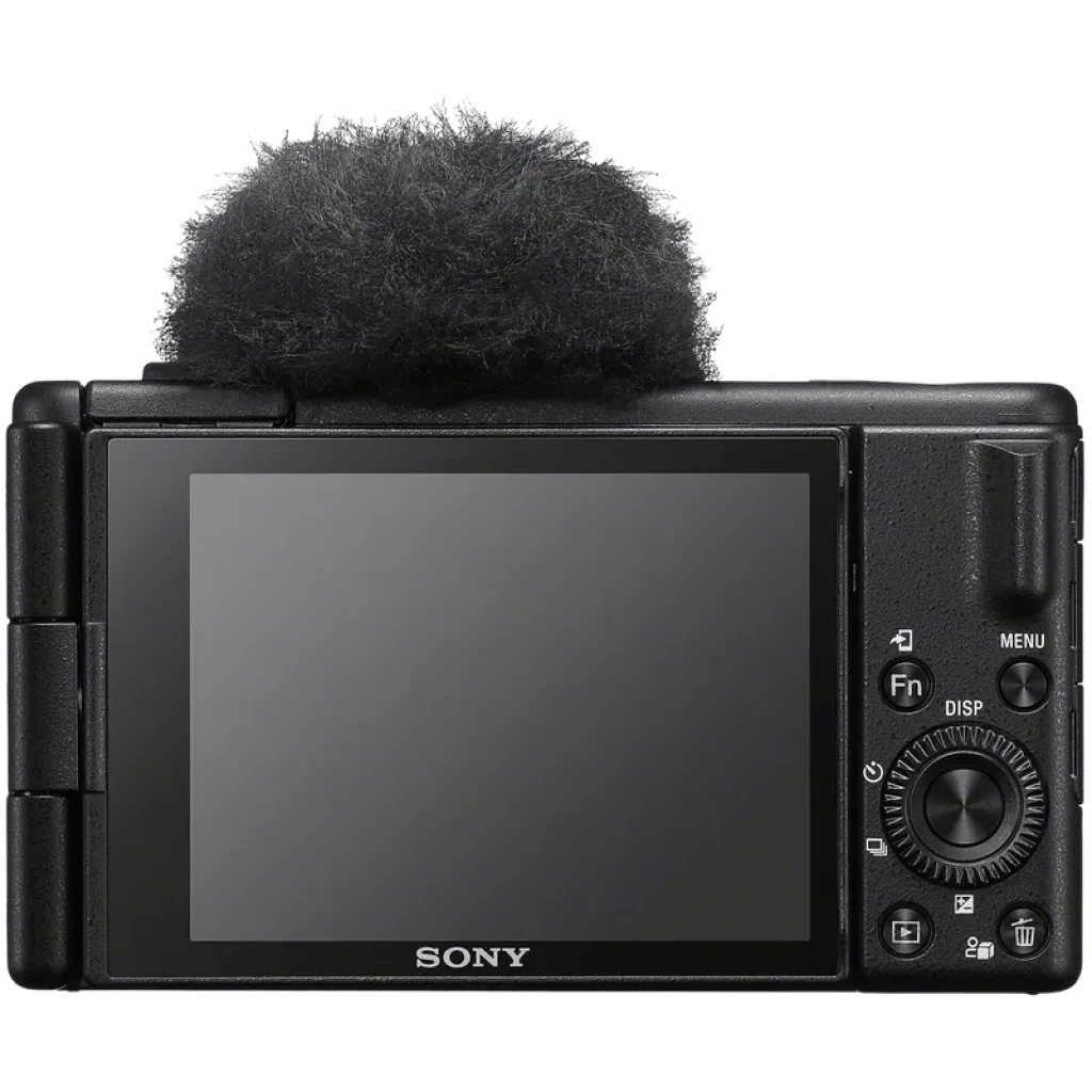 Pantalla abatible trasera de la Sony ZV-1 II con controles laterales, dial, botón REC y zapata con paraviento montado; diseño compacto para vlogging 4K