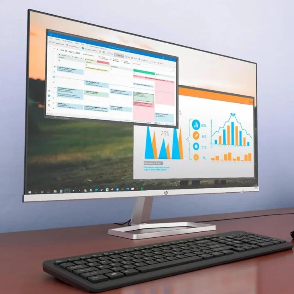 Monitor HP M27fq numa secretária de escritório, exibindo um ecrã IPS com cores precisas