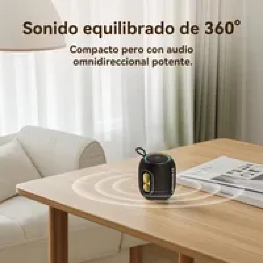 Tronsmart T8 Mini 16 W IPX7 – petite enceinte noire avec poignée, anneau lumineux vert, deux boutons dorés, son 360° diffusé sur une table en bois