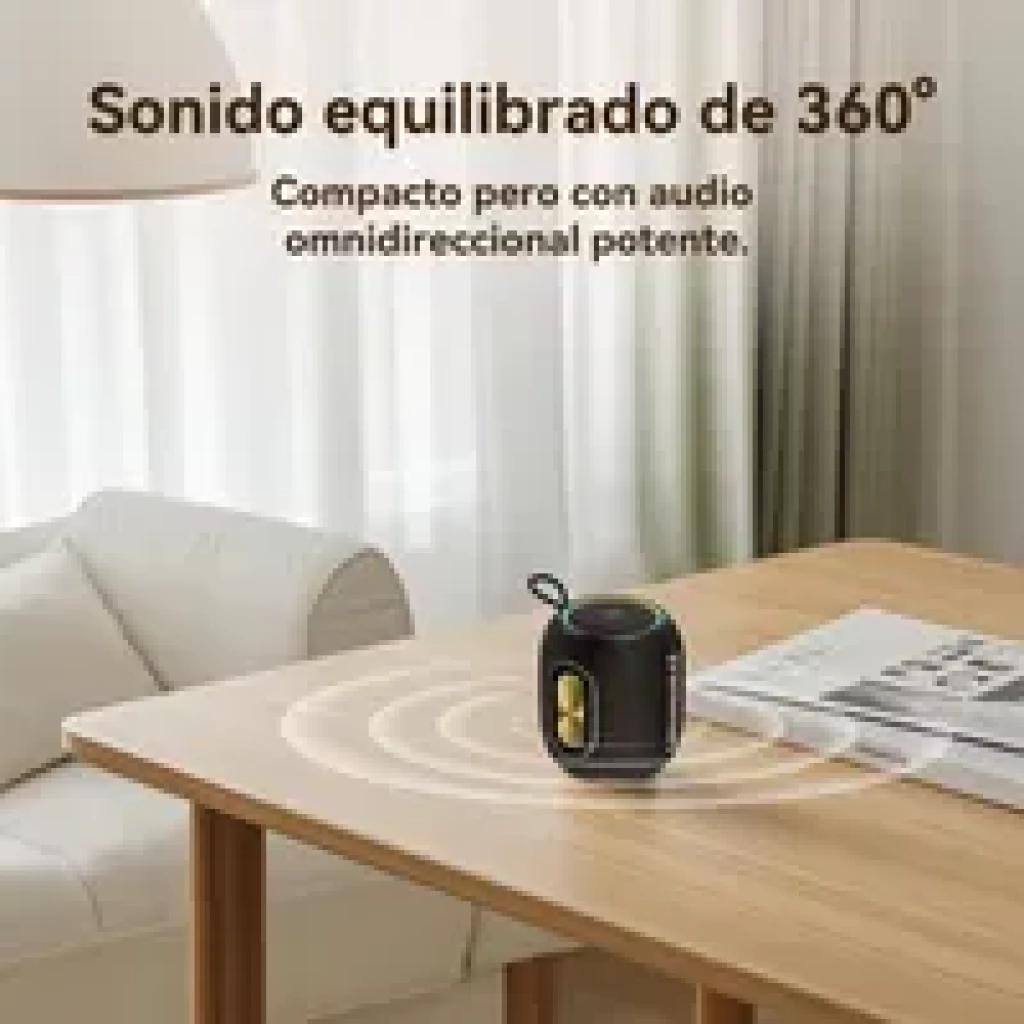 Tronsmart T8 Mini 16 W IPX7 – petite enceinte noire avec poignée, anneau lumineux vert, deux boutons dorés, son 360° diffusé sur une table en bois