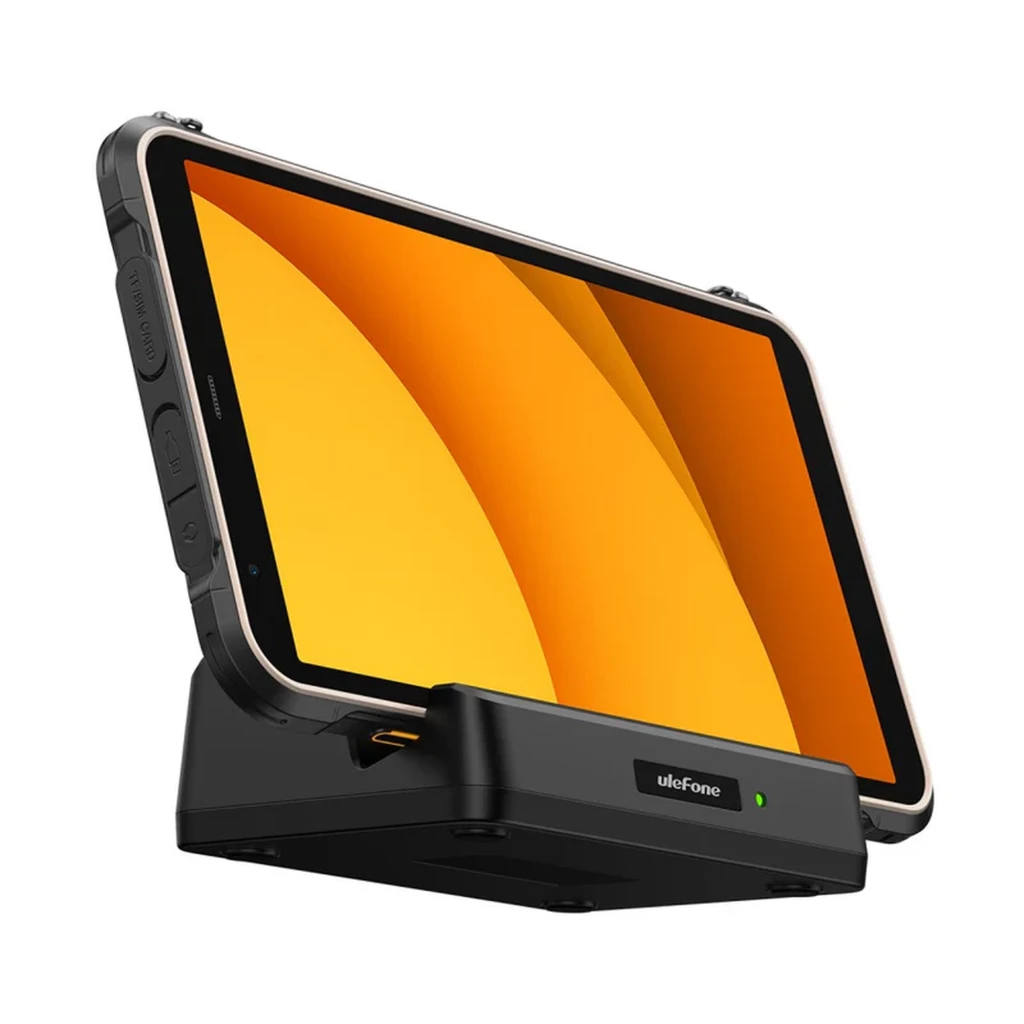Tablet rugerizada amarilla en base de carga, pantalla 8.68 pulgadas, bordes reforzados, botones laterales grandes, puerto visible y LED indicador en la base