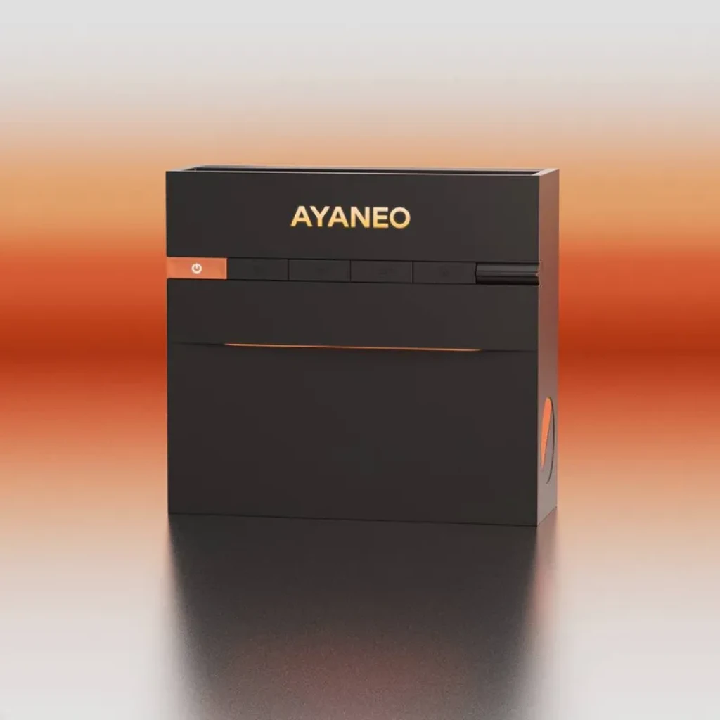Ayaneo AM03, mini PC compacto en negro mate con logo AYANEO iluminado en naranja, panel frontal con botones y ranuras