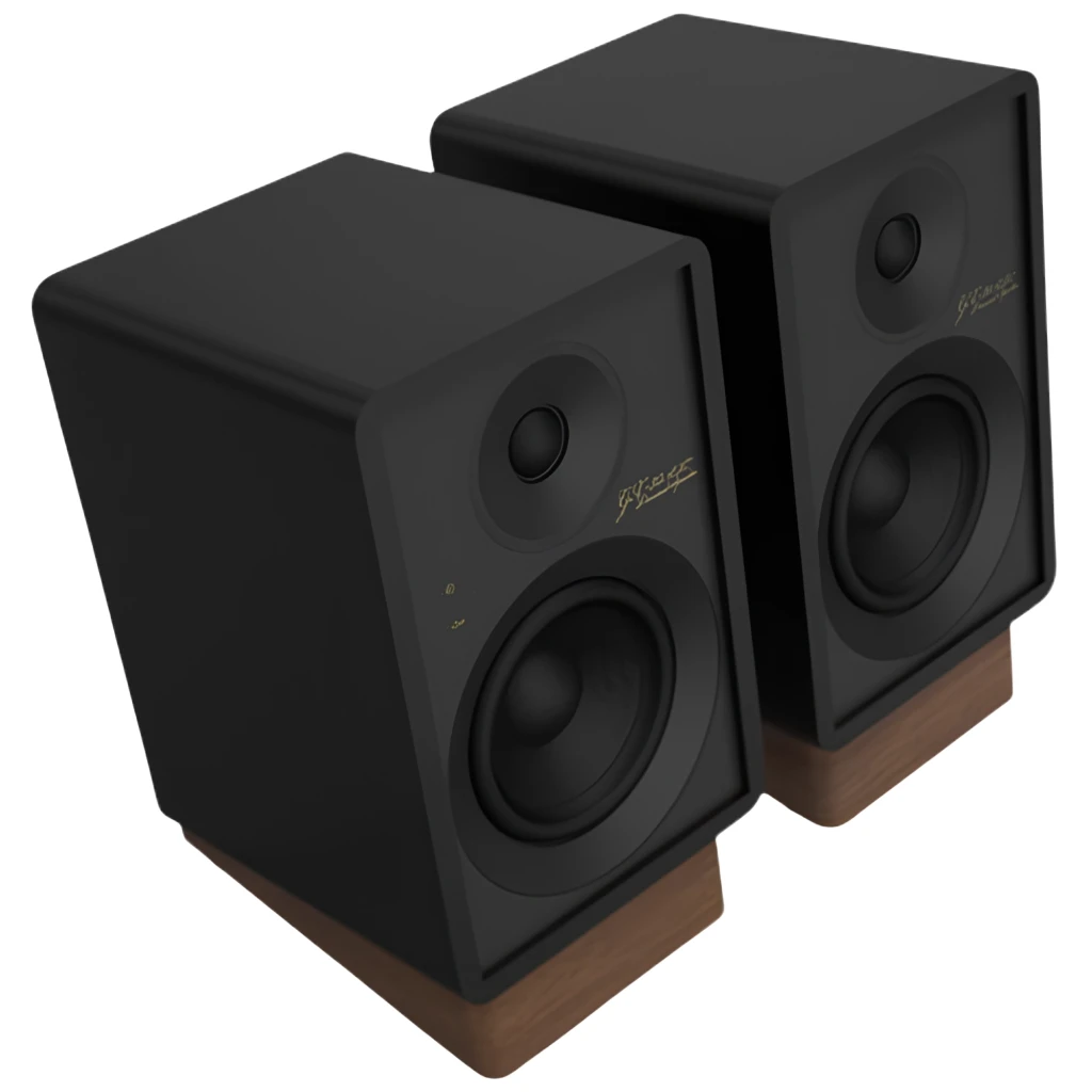 Par de altavoces negros compactos con woofer grande, tweeter superior, controles frontales y base de madera inclinada; diseño minimalista para escritorio