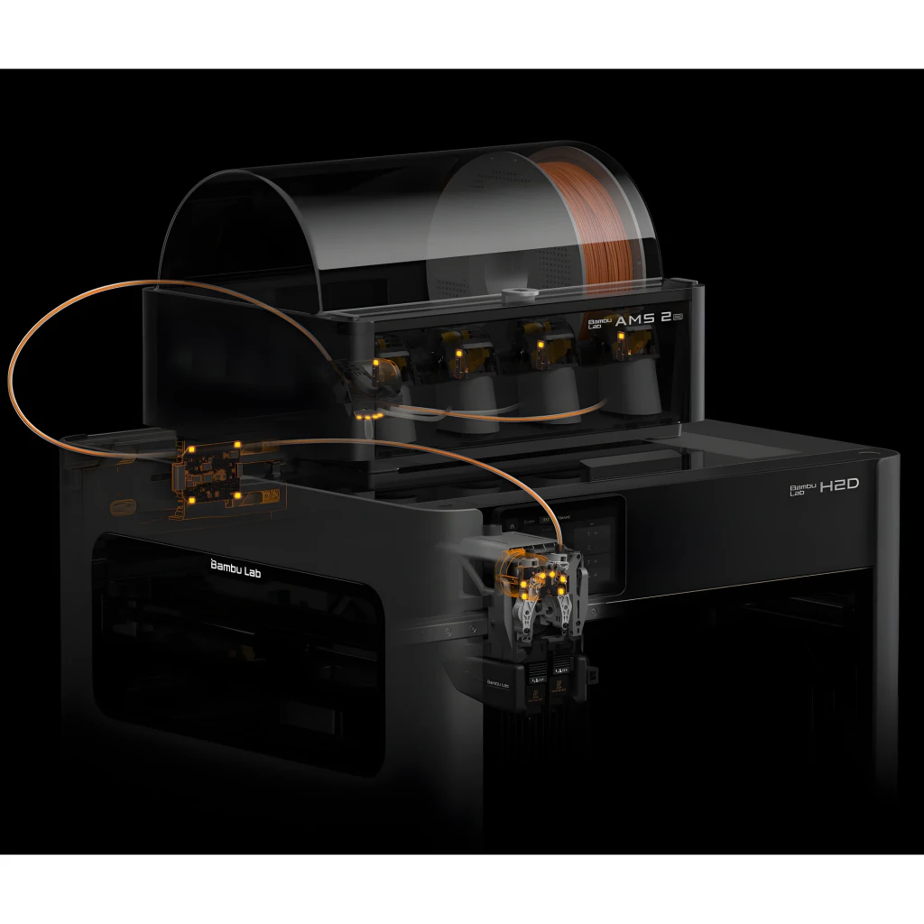 Bambu Lab H2D Pro FDM negra con módulo AMS 2, cuatro ranuras de filamento, cubierta transparente y extrusores iluminados; diseño robusto y moderno