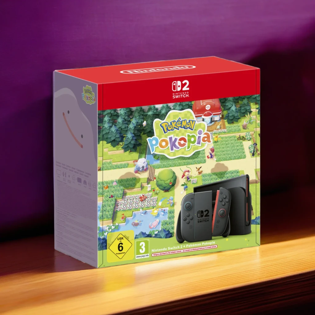 Caja roja con Nintendo Switch 2 256GB y arte colorido de Pokémon Pokopia; se ve la consola gris con Joy‑Con, logo CB2 Switch y clasificación USK 6/PEGI 3