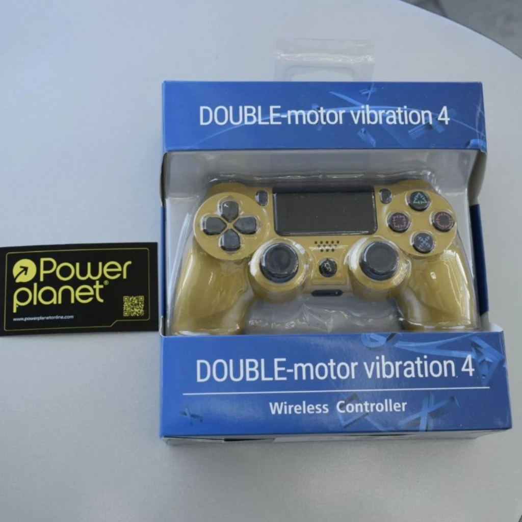 Mando PS4 dorado con panel táctil, botones clásicos, sticks analógicos y gatillos; controlador inalámbrico con vibración doble, presentado en caja azul