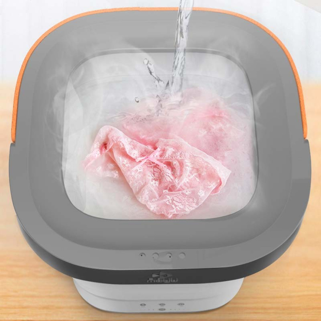 Mini lavadora portátil Moyu XPB08-F1 rosa desprecintado, diseño plegable tipo cubeta, tapa gris con borde naranja, controles frontales y lavado de prendas