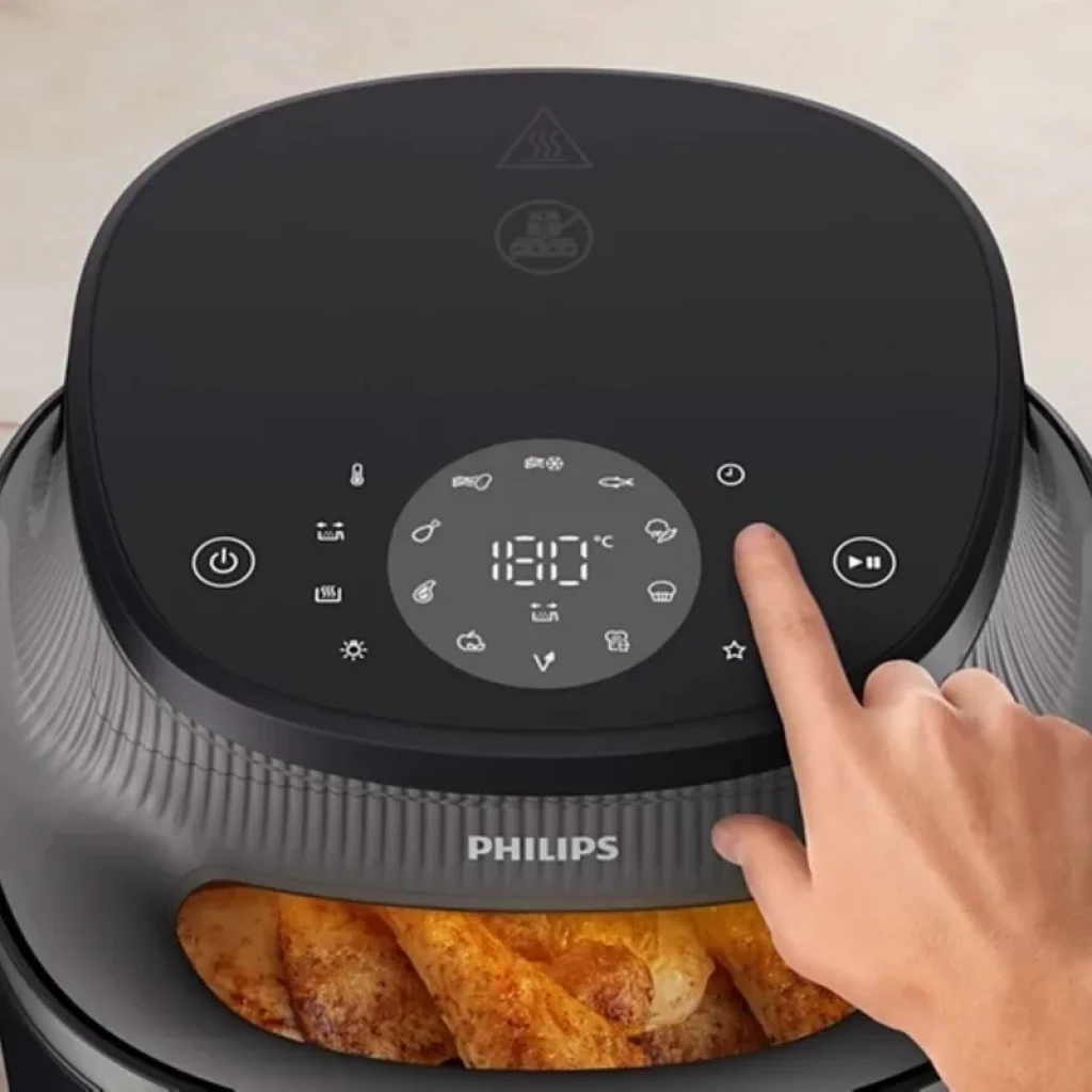 Panel táctil Philips 3000 con pantalla LED 180 °C, iconos de 16 programas y botón de encendido; tapa negra con ventana que muestra alimentos dorándose