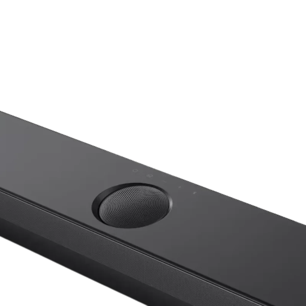 Detalle de la barra LG S70TY negra: control táctil superior, rejilla metálica, dial circular y acabado mate elegante, parte frontal del sistema 3.1.1