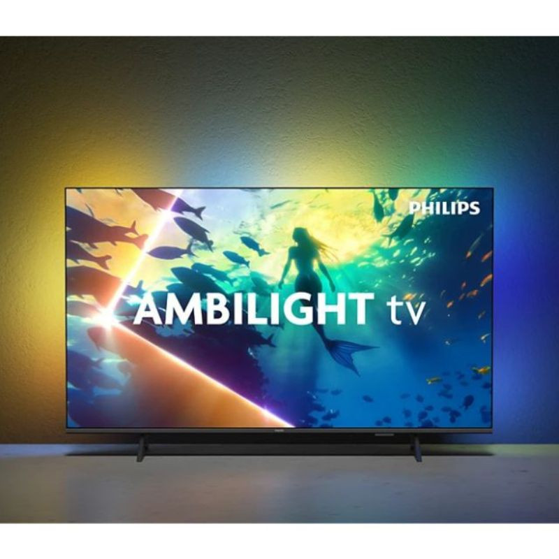 Philips 55PUS8010/12: TV 55" 4K UHD LED preto com Ambilight multicolor, bordas finas e base dupla, imagem vibrante e iluminação imersiva na parede.