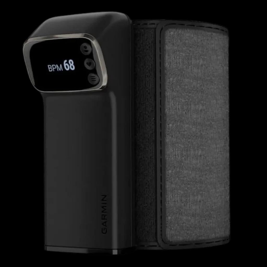 Garmin Index BPM - Tensiómetro inteligente com braçadeira cinzenta em tecido, corpo preto compacto e ecrã digital que mostra BPM 68 com botões laterais