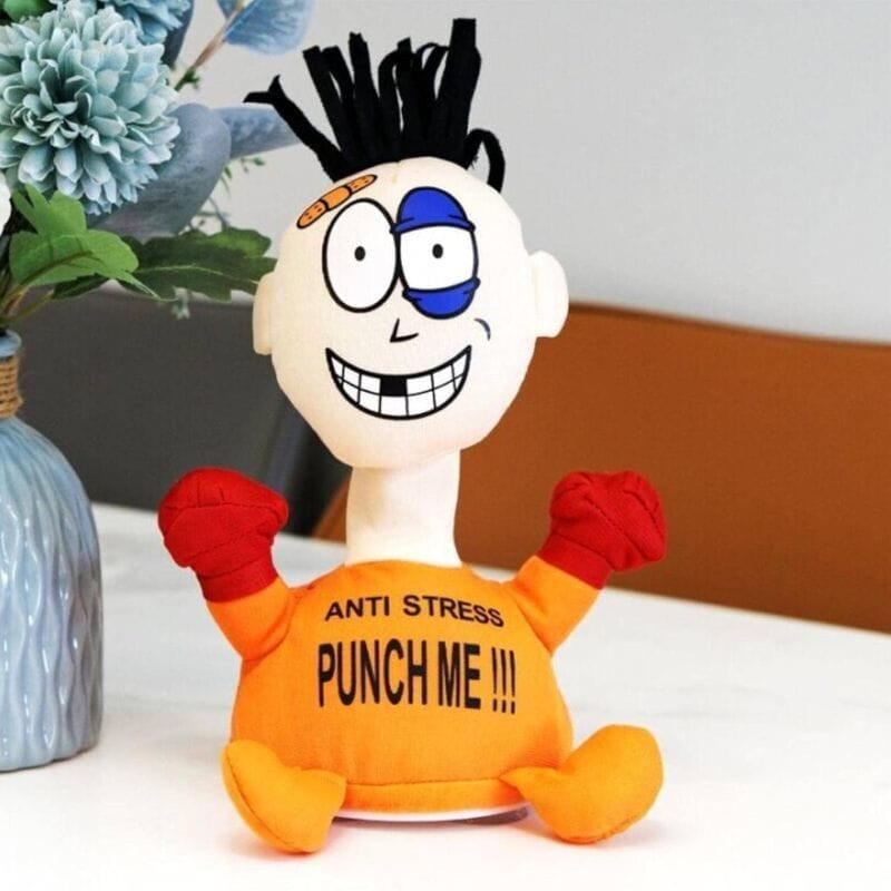 Base del Muñeco Pablo Anti Stress “Punch Me” Naranja: tapa blanca con 3 ventosas y compartimento para 2 pilas AA; cuerpo de tela verde y extremidades